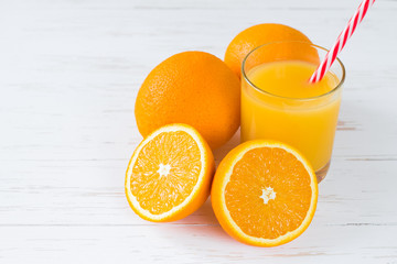 Fresh orange juice on white wooden background. Summer vitamin drinks