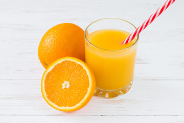 Fresh orange juice on white wooden background. Summer vitamin drinks