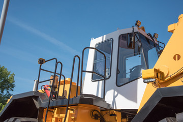 Some parts from a large car for transportation of ore called Belaz, black wheels, blue stairs and others at the exhibition coal and mining