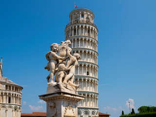 Fototapeta na wymiar Leaning tower and statue of angels in Pisa, Tuscany, Italy.