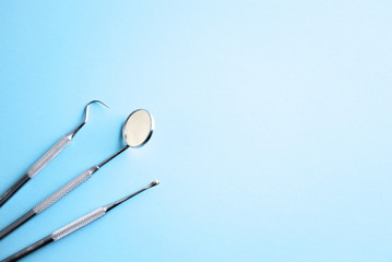 Dental instruments on blue background. Dental care concept. Dental medicine. 