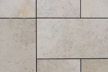 Pale beige floor tiles with dark borders