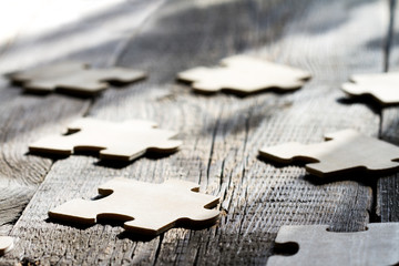 Teamwork in business abstract concept with puzzle on wooden board - obrazy, fototapety, plakaty