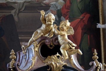 Fototapeta na wymiar Angels, statue on the main altar in Amorbach Benedictine monastery church in Lower Franconia, Bavaria, Germany