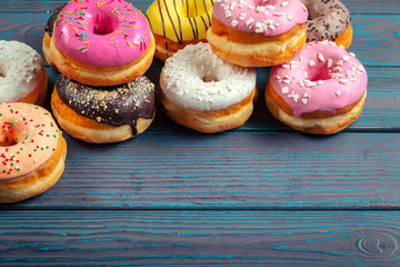 Glazed donuts on wooden background