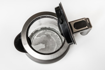 Limescale at the bottom of kettle - hard water concept
