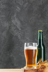 Single beer glass close up on dark stone background