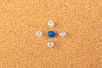 Group of thumbtacks pinned on corkboard