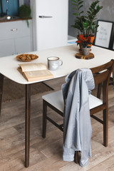 Breakfast time and kitchen place with coffee mug on wooden desk with opened book 