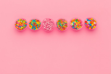 Sugar sprinkles  food background on pink cardboard