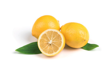 Ripe lemon with green leaves