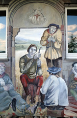 Obraz na płótnie Canvas The scenes of pilgrims on their way to Santiago de Compostela, fresco by Sieger Koder on the wall of the pilgrimage house of St. James in Hohenberg, Germany