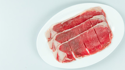 raw beef on a plate .