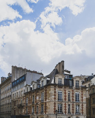 Parisian buildings under clouds and sky in Paris, France
