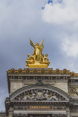 Fototapeta na wymiar Golden statue on the frontal facade of Palais Garnier in Paris, France