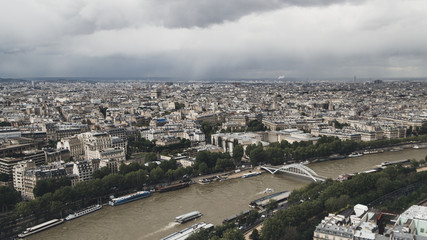 Obraz premium View of the city of Paris, France from top of Eiffel Tower on a cloudy day