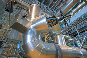 Equipment, cables and piping as found inside of a modern industrial power plant