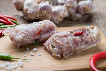 Sour Pork (Nham), a Thai northeastern style food made with mixed pork, rice, garlic, sugar and salt in banana leaf package, fermented-pork