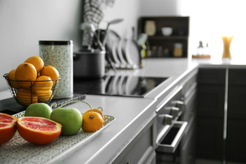 Tray with fresh fruits on counter in kitchen