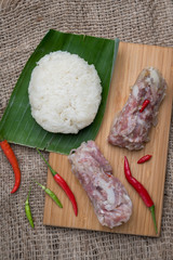 Sour Pork (Nham), a Thai northeastern style food made with mixed pork, rice, garlic, sugar and salt in banana leaf package, fermented-pork