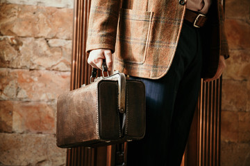 man with bag and  jacket is in house