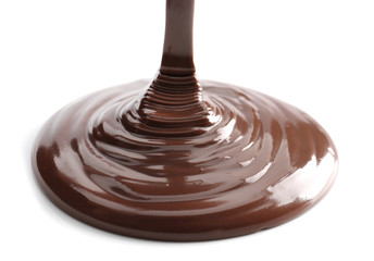 Pouring melted chocolate on white background