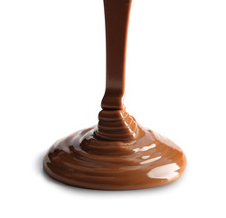 Pouring melted chocolate on white background