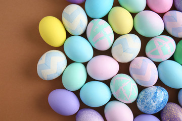 Many beautiful Easter eggs on color background