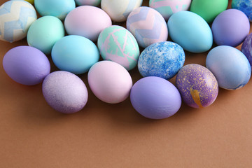 Many beautiful Easter eggs on color background