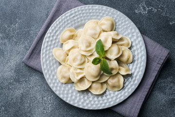 Dumplings stuffed with meat, ravioli, dumplings. Dumplings with stuffing. Russian cuisine.