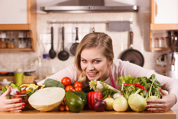 Woman having vegetables on table