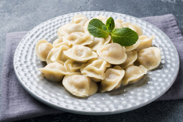 Dumplings stuffed with meat, ravioli, dumplings. Dumplings with stuffing. Russian cuisine.