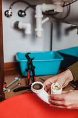 Hands hold  detail of  hydraulic shutter kitchen sink