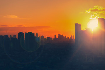 Sunset view of city skyline with bright emotional and powerful energy from light.  First sunlight...
