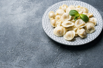Dumplings stuffed with meat, ravioli, dumplings. Dumplings with stuffing. Russian cuisine. Copy space.