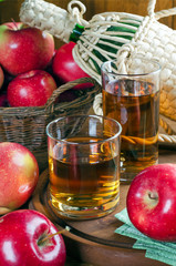 Apple juice in glasses, apples and bottle.