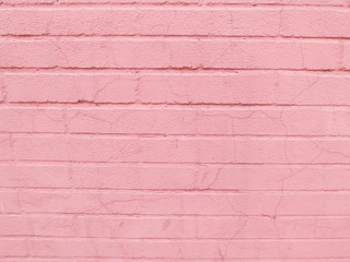 Pink brick wall of ancient building with cracks