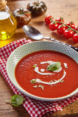 Plate of tomato cream soup. Rustic kitchen