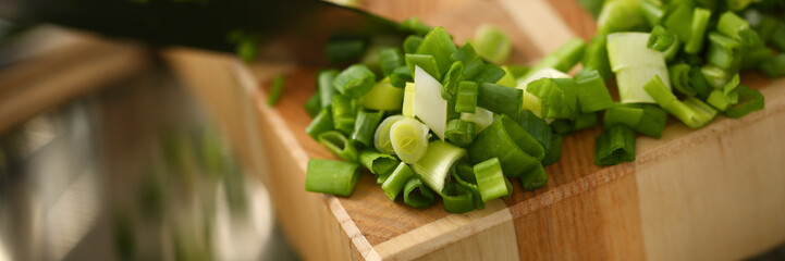 Cook holds knife in hand and cuts on cutting