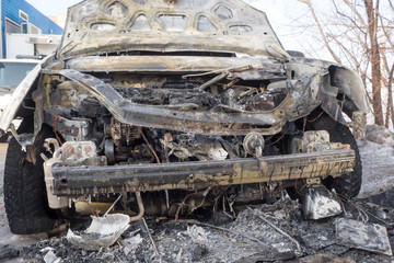 Fototapeta premium Burned car, burned-out car body. Machine after a fire close up.Car insurance.