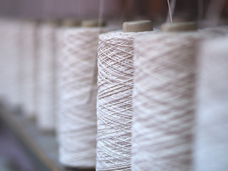 Row of textile threads industry .