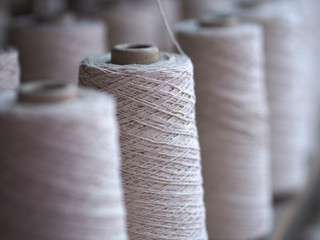 Row of textile threads industry .