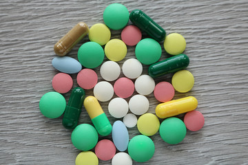 A lot of multi-colored tablets of different shapes. Pills are used in medicine to heal people.