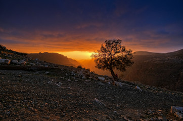 Dramatic orange sunset in Dana mountains in Jordan