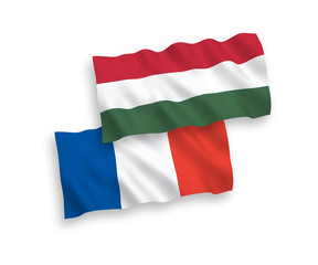 Obraz premium National vector fabric wave flags of France and Hungary isolated on white background. 1 to 2 proportion.