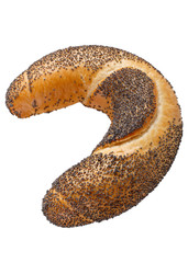 Crescent rolled bun with poppy seeds isolated on white background. Freshly baked bagel close-up.