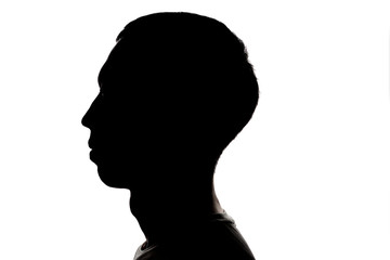 Dark silhouette profile of a young man on a white background, the concept of anonymity