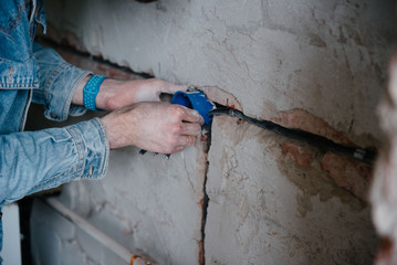 Worker inserts an electrical outlet box