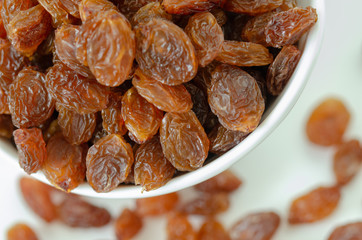 Raisins on white background,top view.