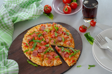 Slice of tasty pizza on the wooden board.